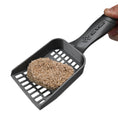 Load image into Gallery viewer, Picture of clumped hemp kitty litter in a  scooper.
